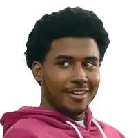 a man wearing a pink hoodie is smiling with his eyes closed