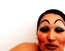a close up of a woman 's face with big eyebrows