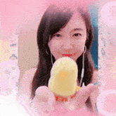 a girl holding a yellow item with the word ice cream on it