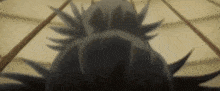 a close up of a person 's face with spikes on it 's head .