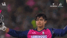 two cricket players are standing next to each other and one is wearing a bkt jersey