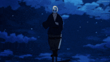 a man with a mask on his head stands on a pole in the dark