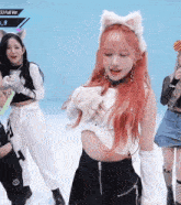a girl with red hair has a cat ear headband on