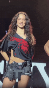 a woman wearing a black shirt that says ' dont tell anyone ' on it