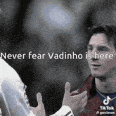 a man talking to another man with the words " never fear vadinho is here " above him