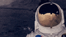 a close up of an astronaut 's helmet with a nasa patch on it
