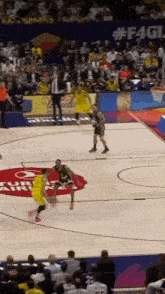 a basketball game is being played on a court with a # f4g logo