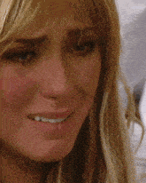 a close up of a woman 's face with a tear running down her cheek
