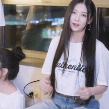 a woman wearing a white authentic t-shirt