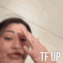 a blurry picture of a woman 's face with the words tf up on the bottom