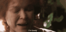 a close up of a woman crying with the words `` i 'm lonely '' written on her face .