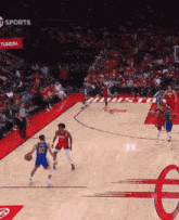 a basketball game is being played on a court that has the word sports written on it