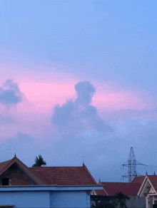a cloud shaped like a dog is visible in the sky over a residential area