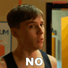 a man in a black tank top is making a face and saying no