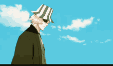 a man wearing a green and white hat and sunglasses stands in front of a blue sky