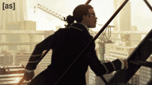 a cartoon of a man standing on a building with the word [ as ] on the top right