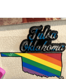 a sticker that says tulsa oklahoma with a rainbow