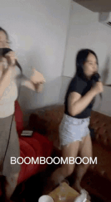 a woman singing into a microphone with the words boomboomboom written below her