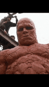 a statue of a man with a very large face
