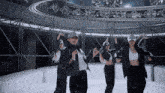 a group of women wearing hats and jackets are dancing