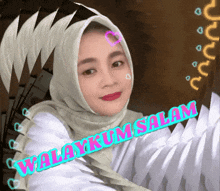 a woman wearing a hijab with the words waliykum salam written on the bottom