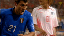a soccer player with the number 21 on his shirt