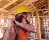 a construction worker wearing a hard hat and safety vest adjusts his helmet