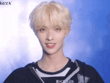 a young man with blonde hair is wearing a black and white shirt with the word ace on it