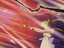 a girl in a white dress is holding a wand in her hand .