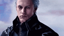 a man with blue hair is wearing a black jacket and standing in front of a cloudy sky .