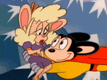 a cartoon of mickey mouse holding a woman in his arms .