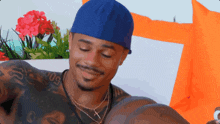 a man wearing a blue hat has a tattoo on his arm that says 09
