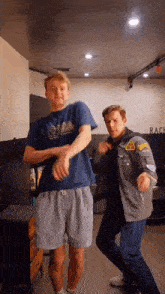 two men are dancing in a room with the word race on the wall