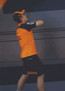 a man in an orange shirt is jumping in the air with the word no written below him