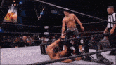 two men are wrestling in a ring with the word aew on the bottom of the screen