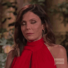 a woman in a red dress with bravo on the bottom