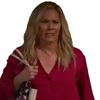 a woman wearing a red shirt is holding a white purse