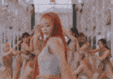 a woman with red hair is dancing in a room