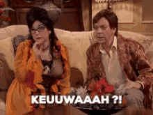 a man and a woman are sitting on a couch and the woman says keuwaaah