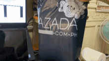 a bag that says ' azada ' on it sits on a desk