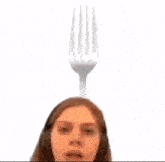 a close up of a woman wearing headphones and a radio antenna on her head .
