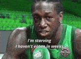a basketball player in a green uniform says i 'm starving and i haven 't eaten in weeks