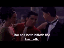 a man in a tuxedo and a woman in a green dress are dancing with the words the shit hath hiteth the fan