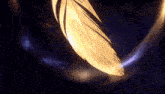 a yellow feather is floating in the air with a blue light behind it
