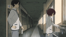 a boy and a girl stand in a hallway next to a toilet