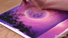 a person is painting a sunset with a brush