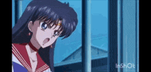 a girl is standing in front of a window with her mouth open .
