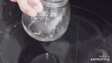 a person is pouring liquid into a glass bowl with the words made in animotica on the bottom