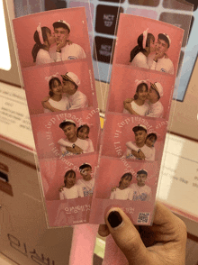 a person holding a couple 's photo booth strips that say special day in life