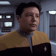 a man in a star trek uniform has a star on his jacket